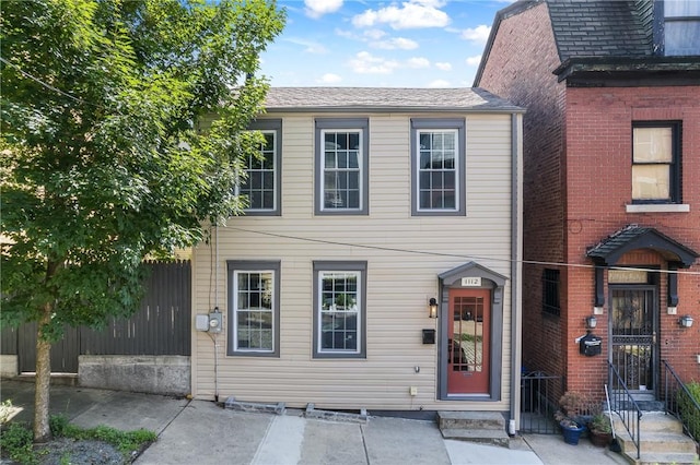 view of front of house featuring entry steps and fence