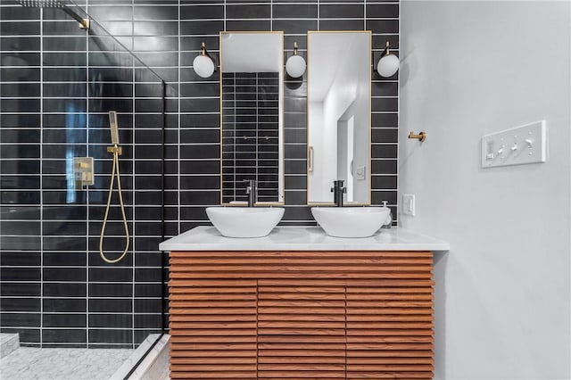 bathroom featuring double vanity, a sink, and walk in shower