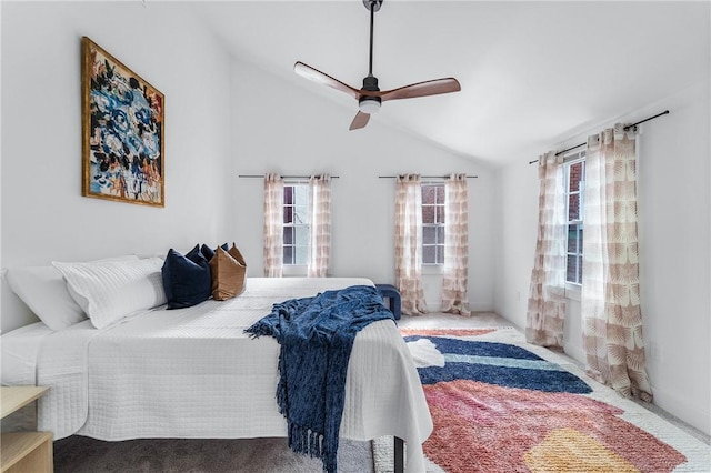 bedroom with vaulted ceiling, carpet floors, and a ceiling fan