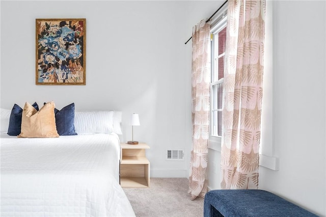 bedroom featuring baseboards, visible vents, and carpet flooring