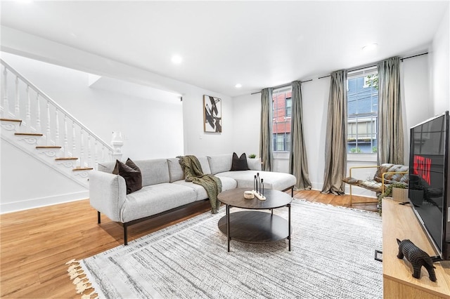 living area featuring stairway, recessed lighting, light wood-style flooring, and baseboards