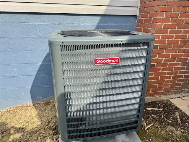 details featuring brick siding and central air condition unit