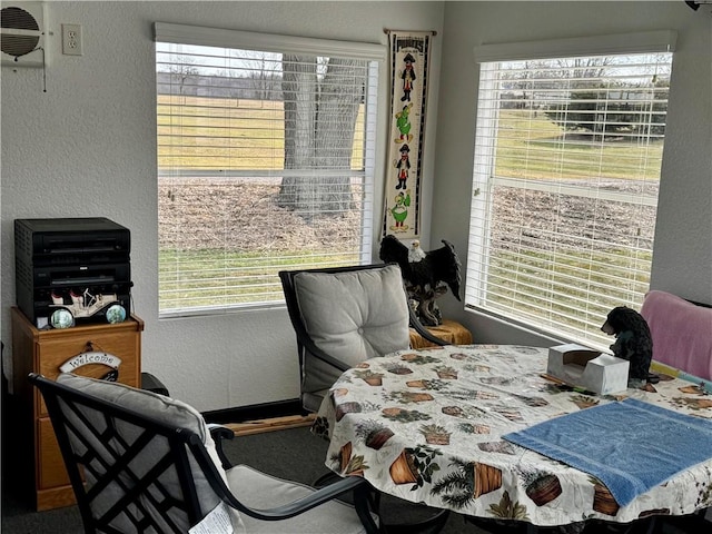 bedroom with a textured wall and a wall mounted AC