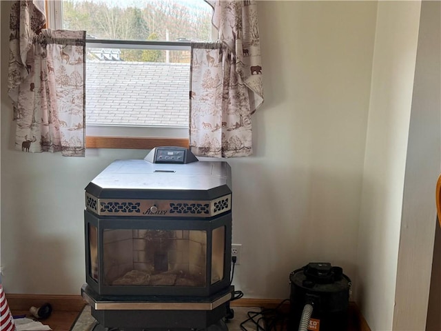 details featuring a wood stove and baseboards