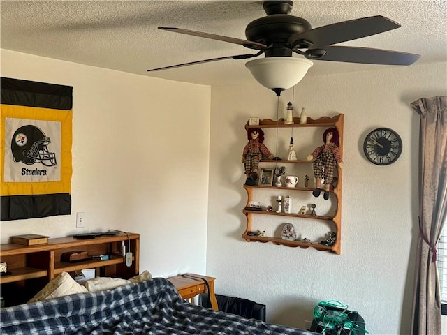 bedroom with a ceiling fan and a textured ceiling