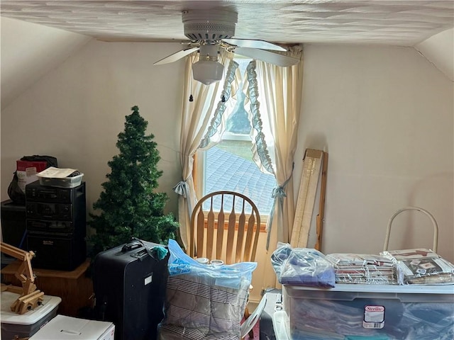 interior space featuring lofted ceiling and ceiling fan