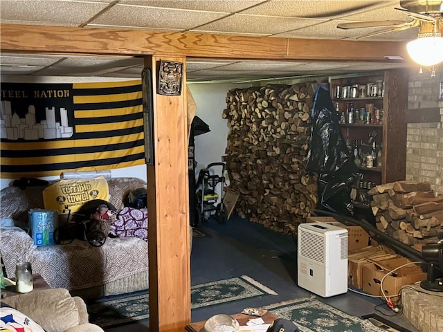 finished basement featuring a paneled ceiling