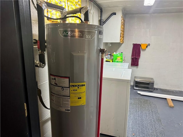 utility room with washing machine and clothes dryer and electric water heater