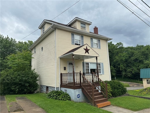 american foursquare style home featuring a chimney