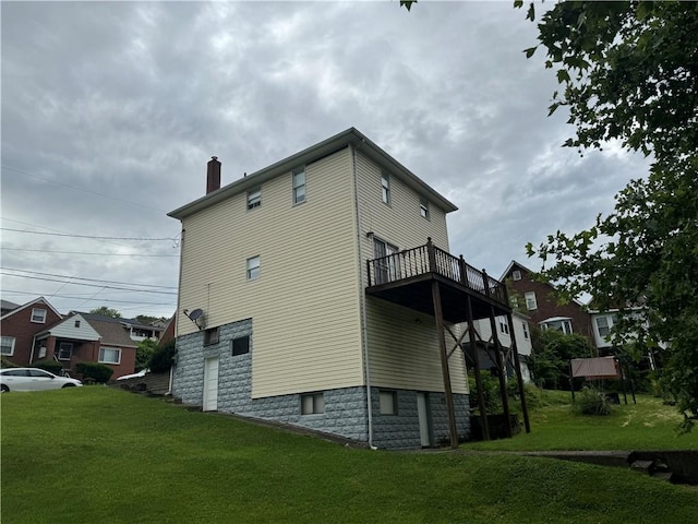 view of side of home featuring a yard and a chimney