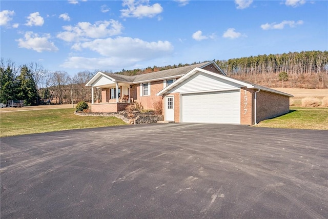 ranch-style house with aphalt driveway, brick siding, a porch, an attached garage, and a front lawn