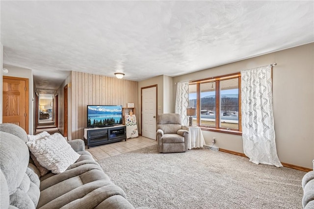 carpeted living room with tile patterned flooring, baseboards, and a textured ceiling