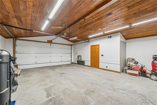 garage featuring a garage door opener, wooden ceiling, and visible vents