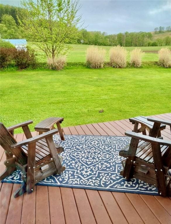 wooden deck featuring a lawn