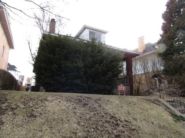 view of property exterior featuring a chimney