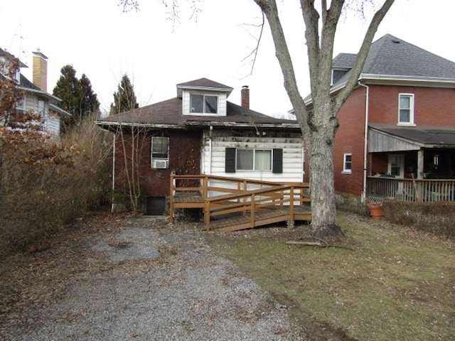 view of front of house featuring a chimney and a wooden deck