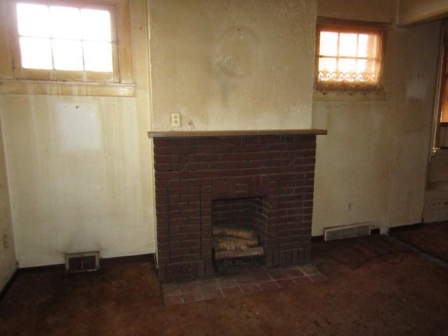 unfurnished living room featuring a fireplace and visible vents