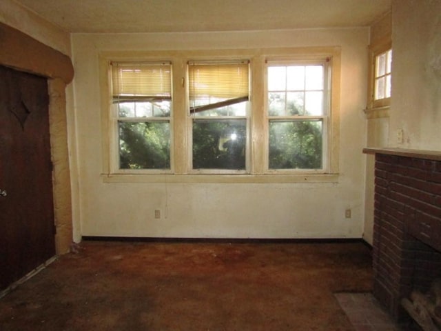 unfurnished room with carpet flooring and a fireplace