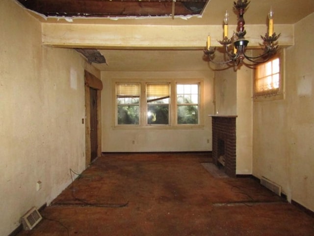 interior space with a brick fireplace, visible vents, and a notable chandelier