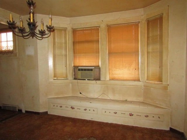 details with cooling unit, visible vents, and an inviting chandelier