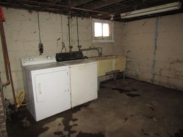 washroom with laundry area, a sink, and washer and clothes dryer