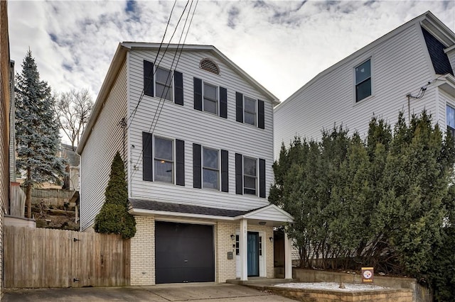 view of front of house featuring a garage, concrete driveway, brick siding, and fence