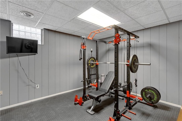 workout area featuring a drop ceiling, visible vents, and baseboards