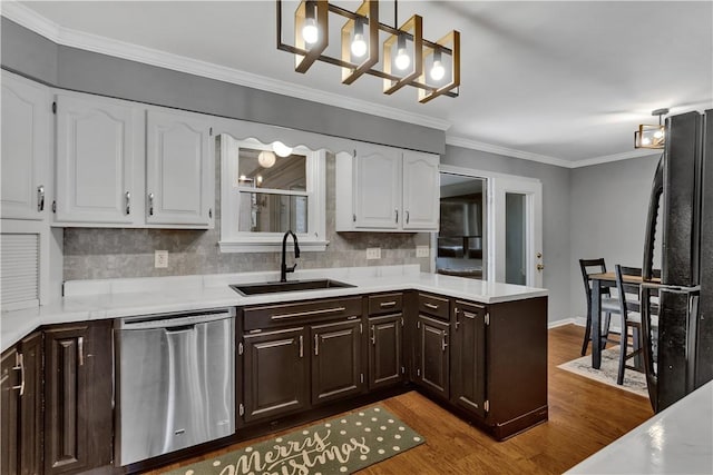 kitchen with dark brown cabinets, stainless steel dishwasher, a sink, and white cabinets