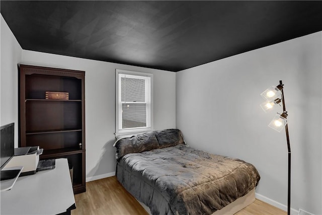 bedroom featuring light wood-style flooring and baseboards