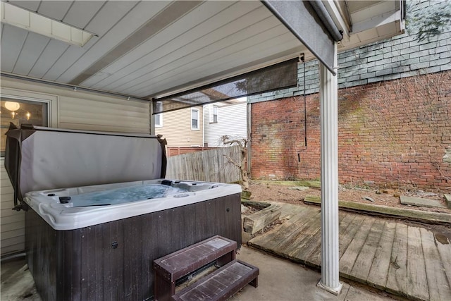 wooden deck featuring fence and a hot tub