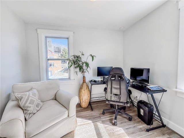 office area featuring baseboards and wood finished floors