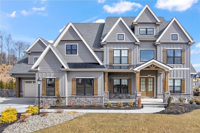 view of front of home with a standing seam roof, board and batten siding, and french doors