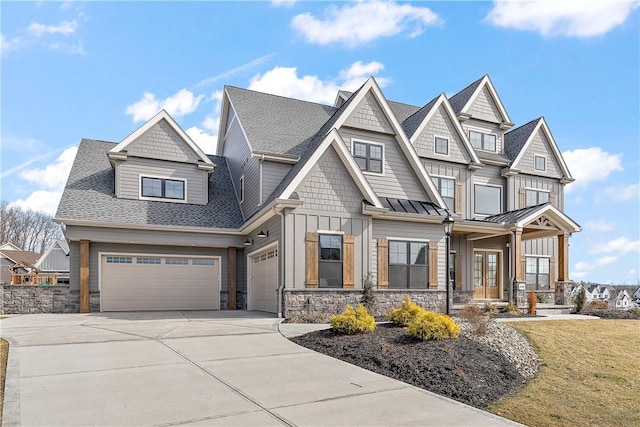 view of front of house featuring a shingled roof, stone siding, french doors, driveway, and board and batten siding