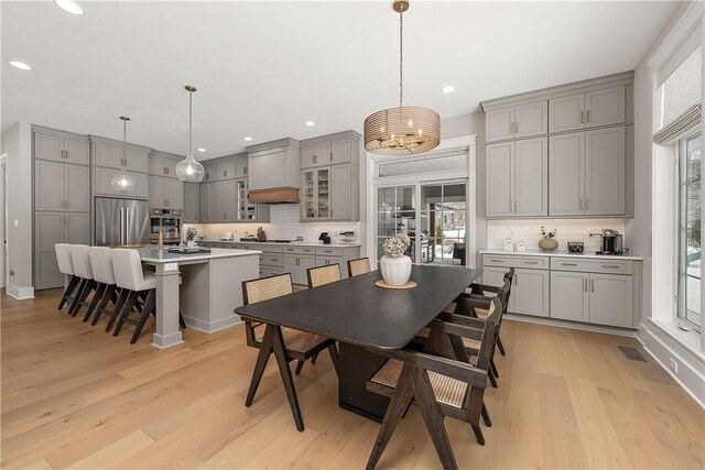 dining room featuring light wood-style floors, an inviting chandelier, and recessed lighting