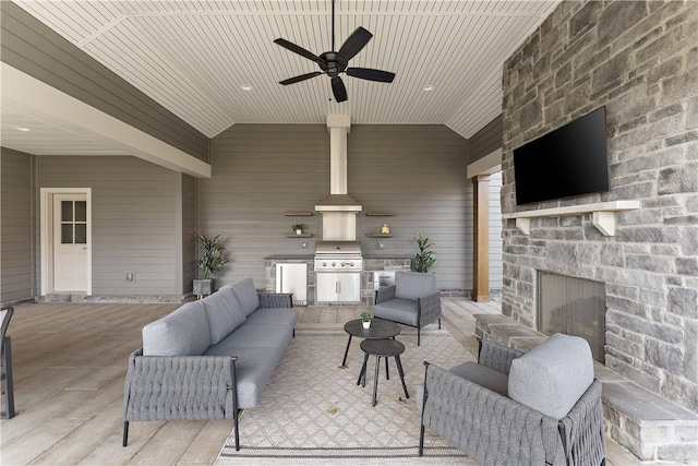 view of patio with a ceiling fan, an outdoor kitchen, grilling area, and an outdoor living space with a fireplace