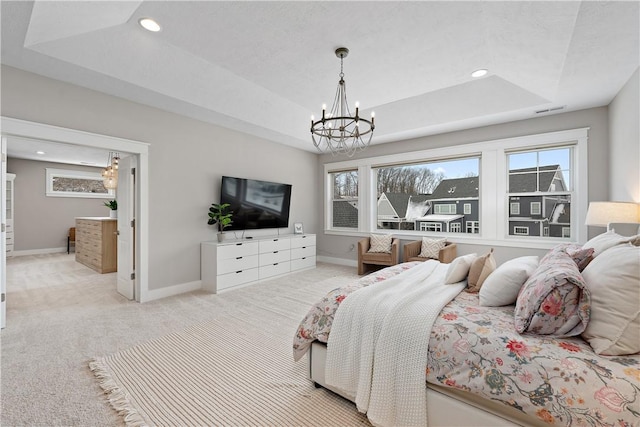 bedroom with visible vents, a raised ceiling, light colored carpet, and baseboards