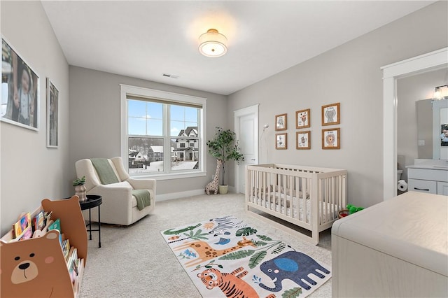 carpeted bedroom with visible vents and baseboards