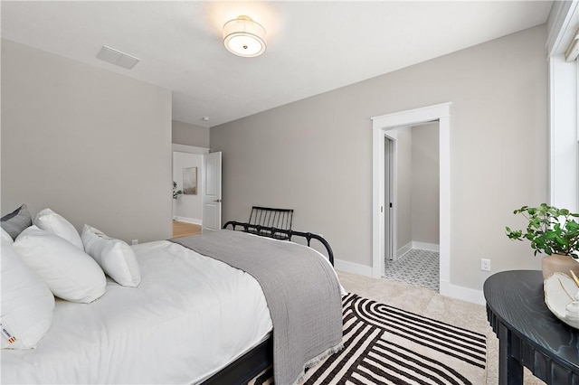 carpeted bedroom with baseboards and visible vents