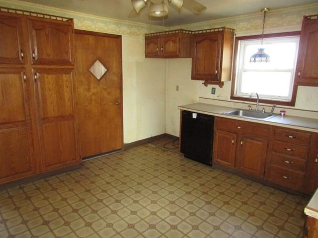 kitchen with a sink, black dishwasher, light countertops, light floors, and crown molding