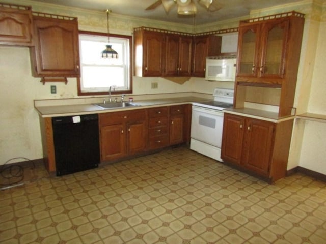 kitchen featuring white appliances, ceiling fan, light countertops, crown molding, and a sink