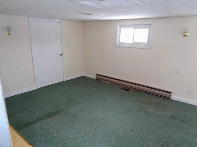 below grade area featuring a baseboard heating unit, carpet flooring, and baseboards