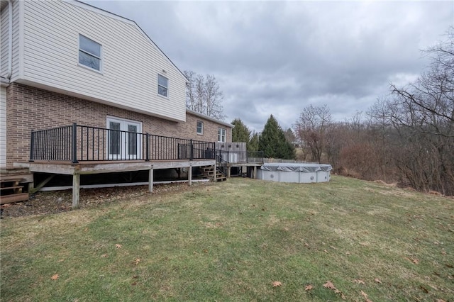 view of yard featuring a covered pool and a wooden deck