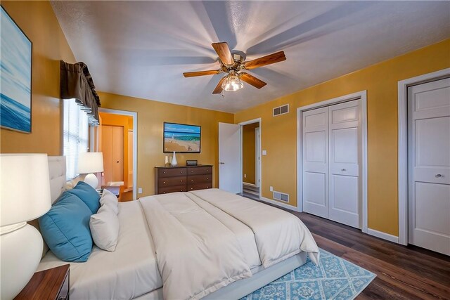 bedroom featuring a ceiling fan, wood finished floors, visible vents, and baseboards