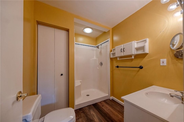 full bathroom with a shower, vanity, wood finished floors, and toilet