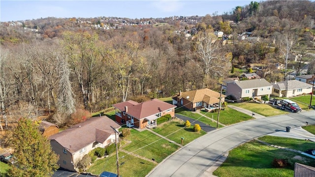 birds eye view of property with a residential view and a view of trees