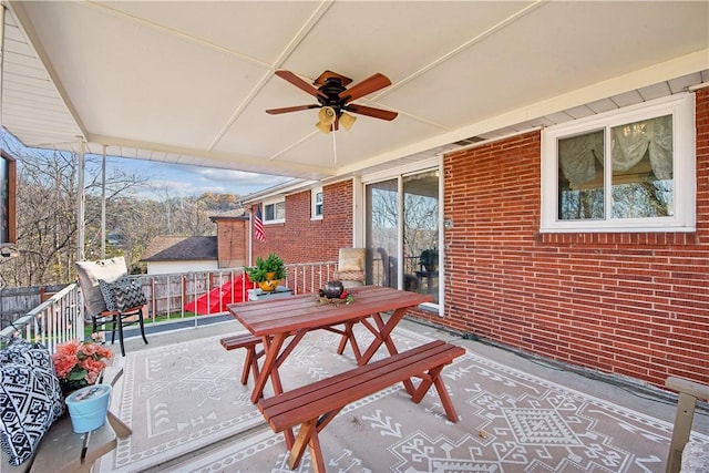 exterior space with fence and a ceiling fan