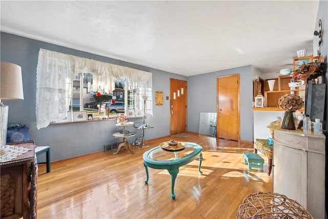 living area featuring wood finished floors and visible vents