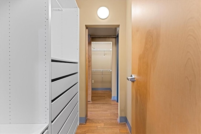 corridor with light wood-type flooring