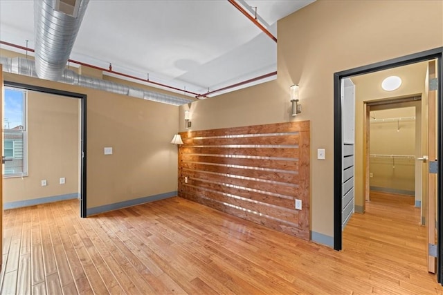 interior space featuring wood finished floors and baseboards