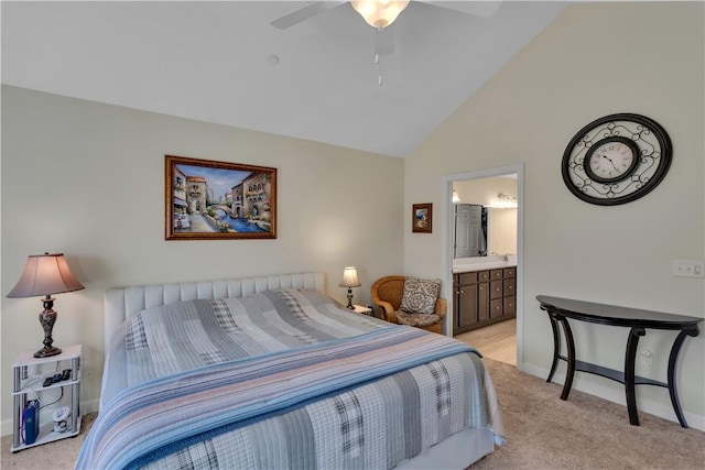 bedroom with ceiling fan, high vaulted ceiling, connected bathroom, light colored carpet, and baseboards